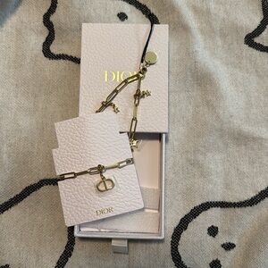 Dior gold tone metal charm cell phone strap! Great gift idea one size fits all